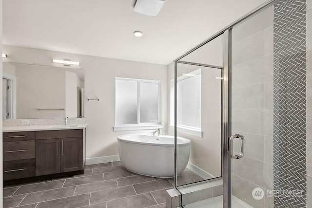 bathroom featuring vanity and separate shower and tub