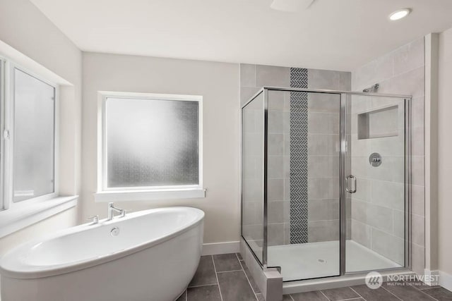 bathroom featuring tile patterned floors and shower with separate bathtub