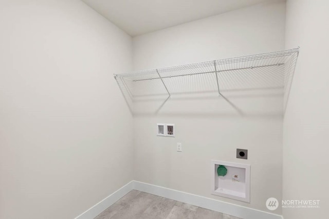 laundry area featuring washer hookup, light hardwood / wood-style flooring, and hookup for an electric dryer