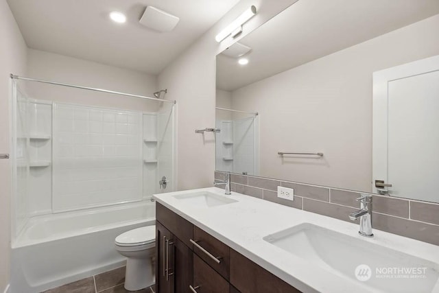 full bathroom with tile patterned floors, toilet, tasteful backsplash, shower / bathtub combination, and vanity