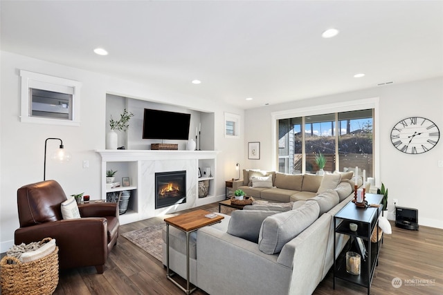 living room with a fireplace and dark hardwood / wood-style flooring