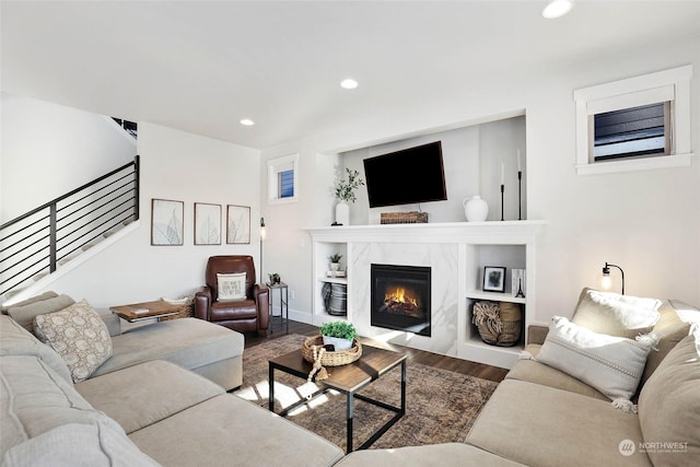 living room featuring hardwood / wood-style floors and a high end fireplace