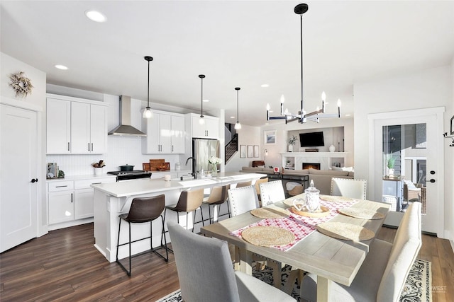 dining space with dark hardwood / wood-style floors and a notable chandelier