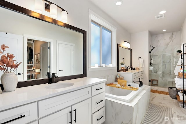 bathroom featuring vanity and shower with separate bathtub