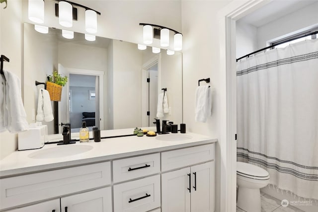 bathroom featuring a shower with curtain, vanity, and toilet