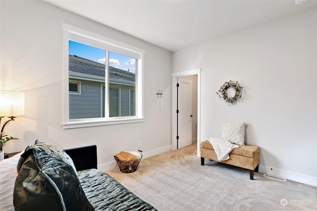 sitting room featuring light colored carpet