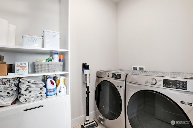 washroom with washing machine and clothes dryer