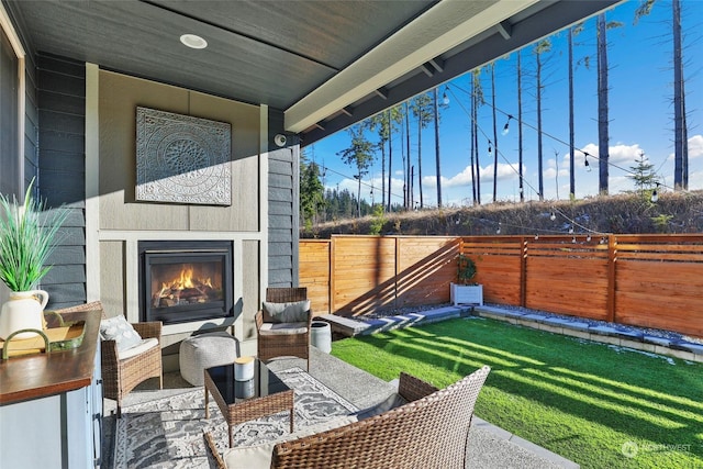 view of patio / terrace featuring an outdoor fireplace