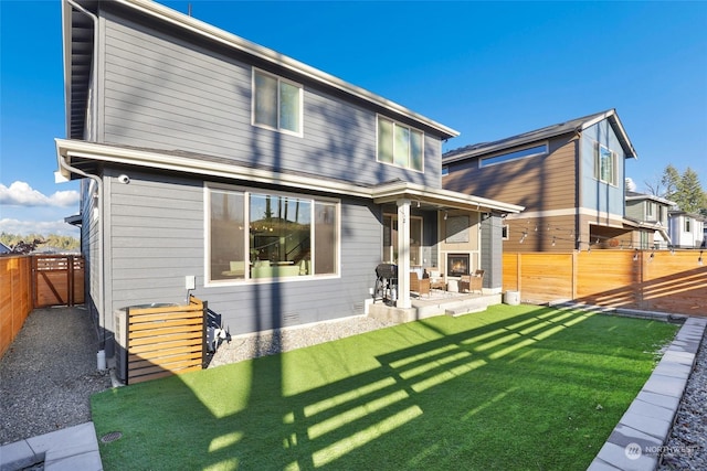 back of house with a yard and a patio area