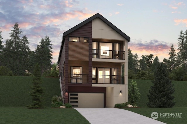 view of front of house with a garage, a balcony, and a yard