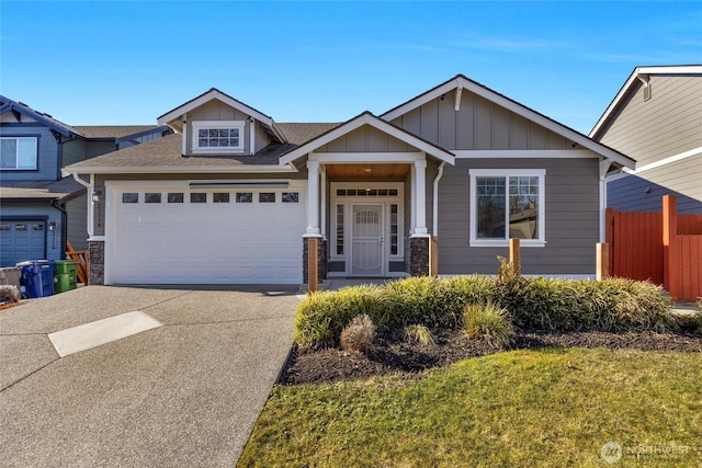 craftsman-style home featuring a garage and a front yard