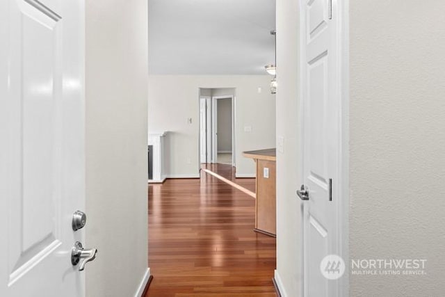 hallway with dark hardwood / wood-style floors