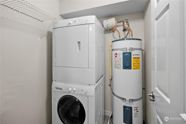 clothes washing area with stacked washer / drying machine and water heater