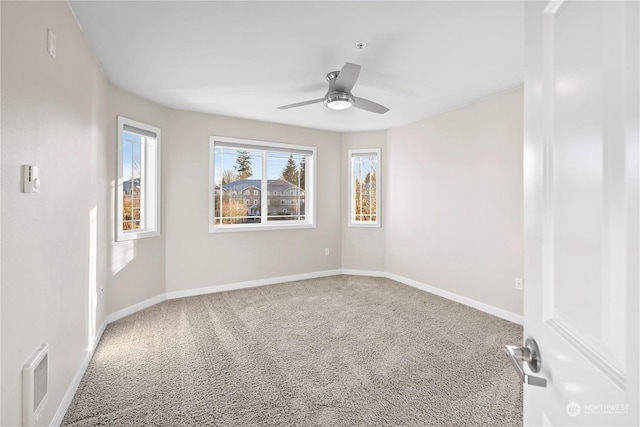 carpeted spare room with ceiling fan