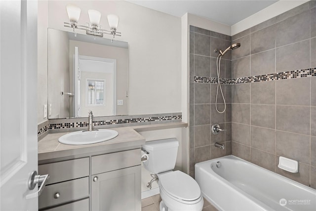 full bathroom featuring tasteful backsplash, vanity, toilet, and tiled shower / bath combo