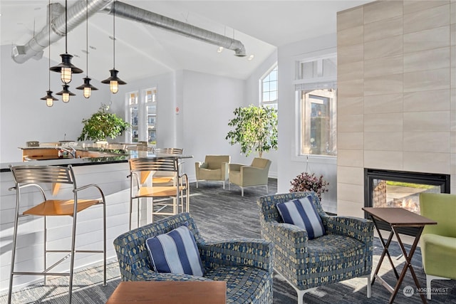 interior space featuring a multi sided fireplace and vaulted ceiling