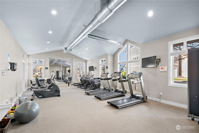 gym featuring vaulted ceiling and carpet flooring