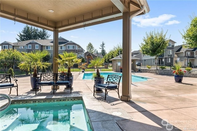 view of swimming pool featuring an outbuilding and a patio area