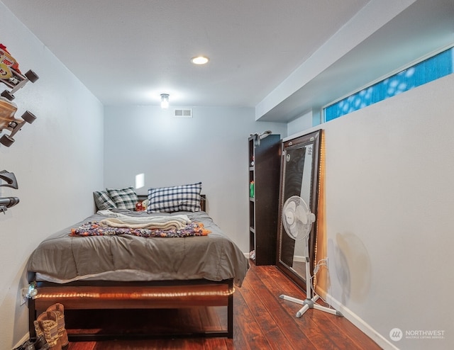 bedroom with dark hardwood / wood-style floors