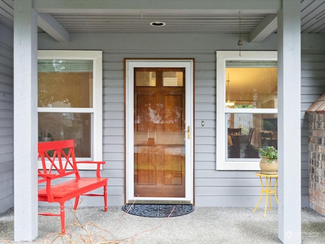 view of exterior entry with a porch