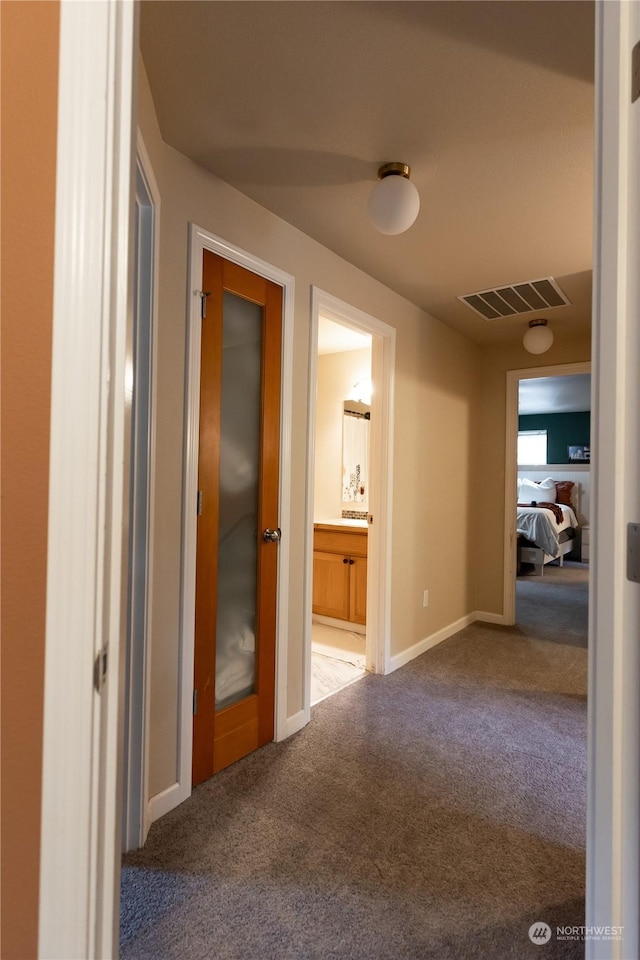 corridor with carpet flooring