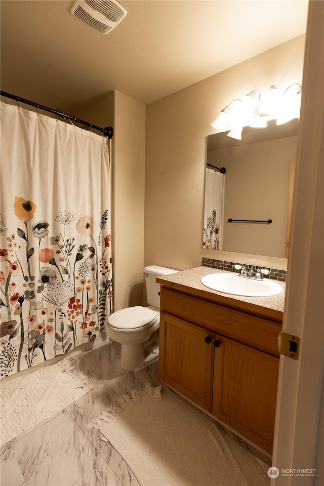 bathroom featuring vanity and toilet