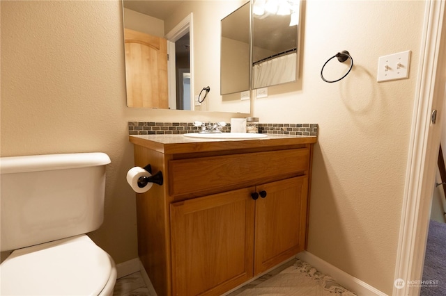 bathroom featuring vanity and toilet