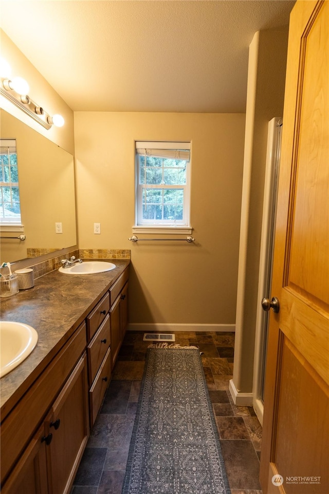 bathroom featuring vanity and a textured ceiling