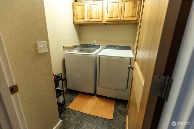 washroom with cabinets and washing machine and dryer