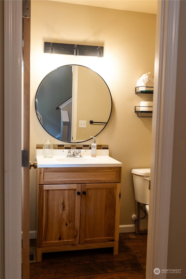 bathroom featuring hardwood / wood-style flooring, vanity, and toilet