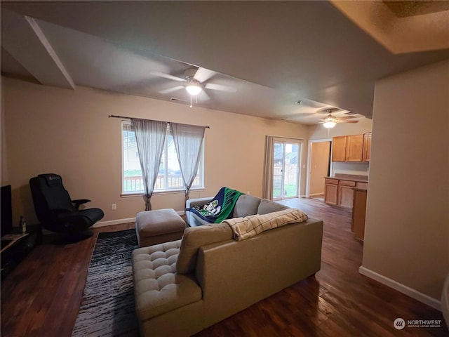 living room with ceiling fan, dark hardwood / wood-style flooring, and a wealth of natural light