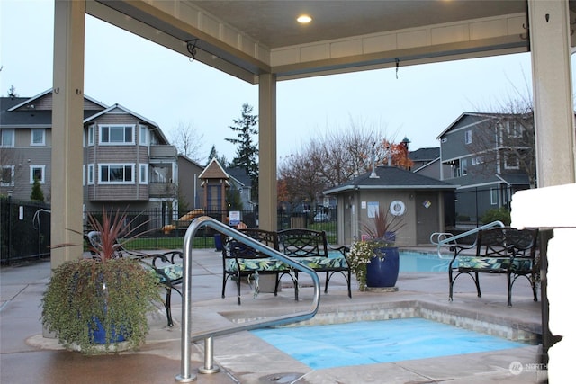 view of swimming pool featuring a patio and an outbuilding