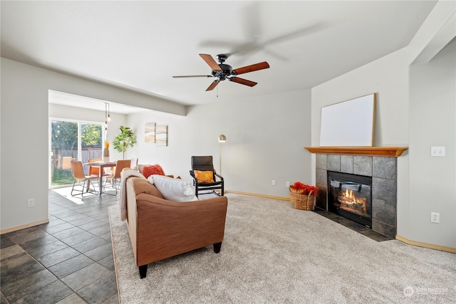 living room with ceiling fan, a fireplace, and carpet flooring