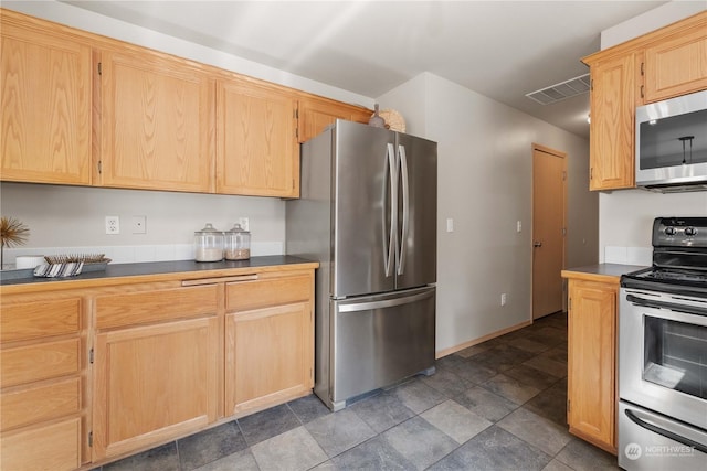 kitchen featuring stainless steel appliances and light brown cabinets