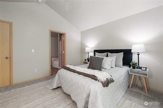 bedroom featuring connected bathroom, carpet flooring, and vaulted ceiling