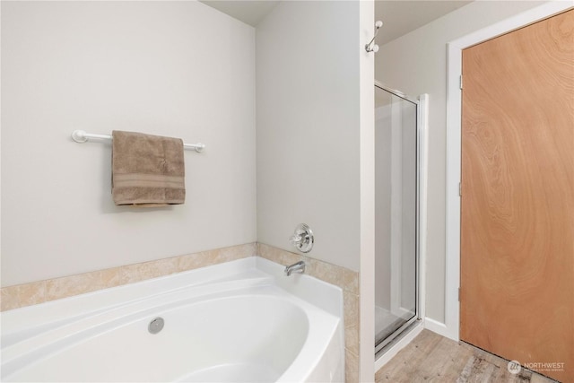 bathroom featuring a shower with shower door and hardwood / wood-style floors