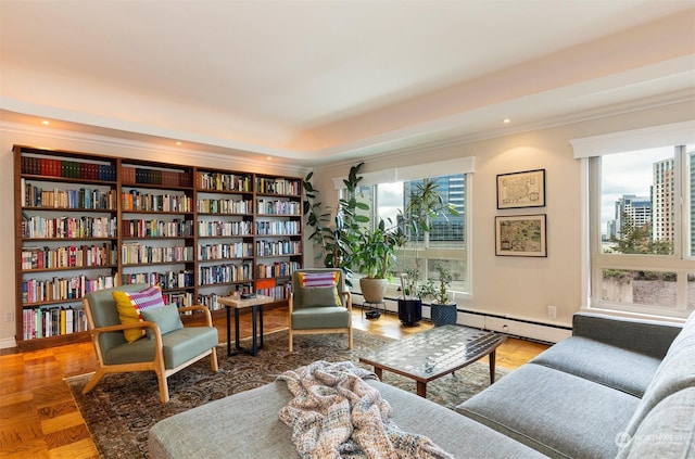 sitting room with parquet floors, crown molding, and a baseboard heating unit