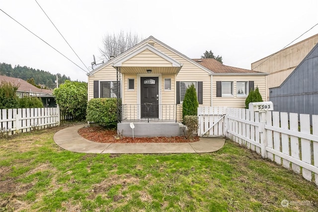 bungalow-style house featuring a front yard