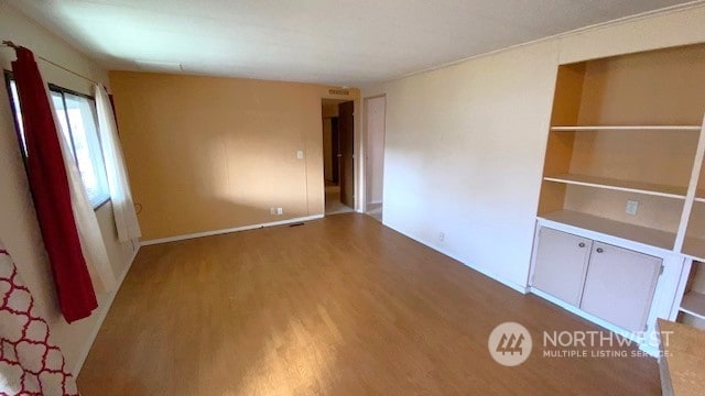 spare room with hardwood / wood-style floors