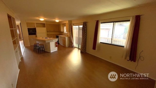 kitchen featuring a breakfast bar area, dark hardwood / wood-style floors, and a kitchen island