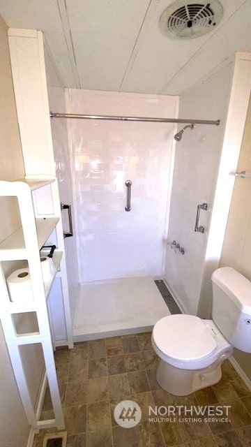 bathroom with a shower and toilet