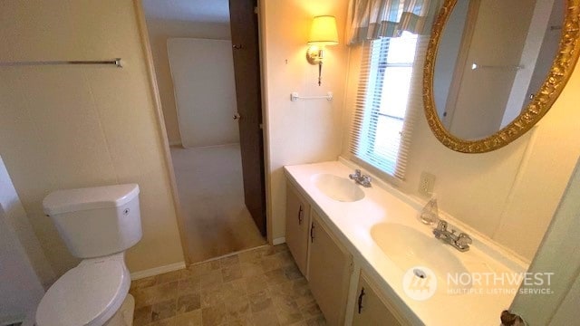 bathroom featuring vanity and toilet