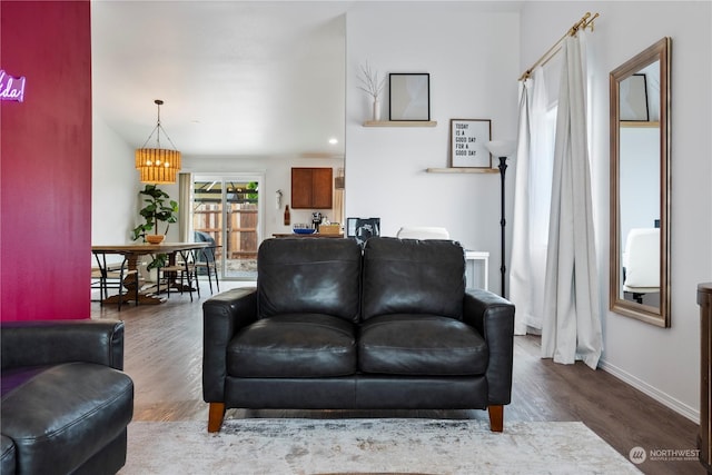 living room featuring dark hardwood / wood-style floors and a notable chandelier