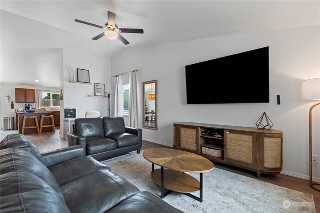 living room with hardwood / wood-style flooring, plenty of natural light, lofted ceiling, and ceiling fan