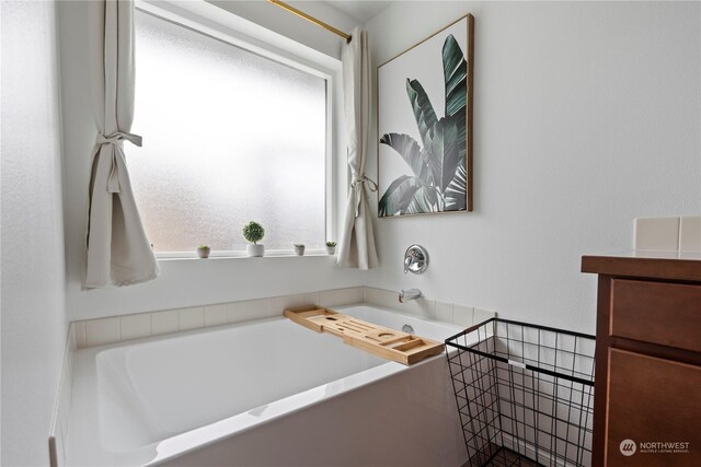 bathroom with vanity and a bathtub