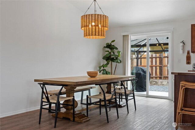 dining space with wood-type flooring