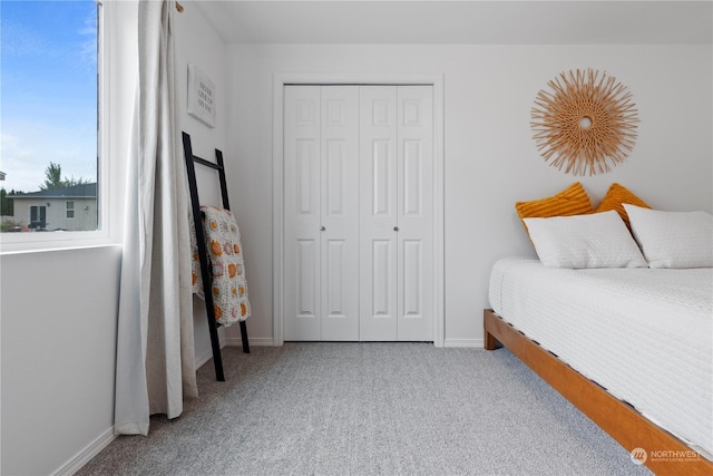 carpeted bedroom featuring a closet