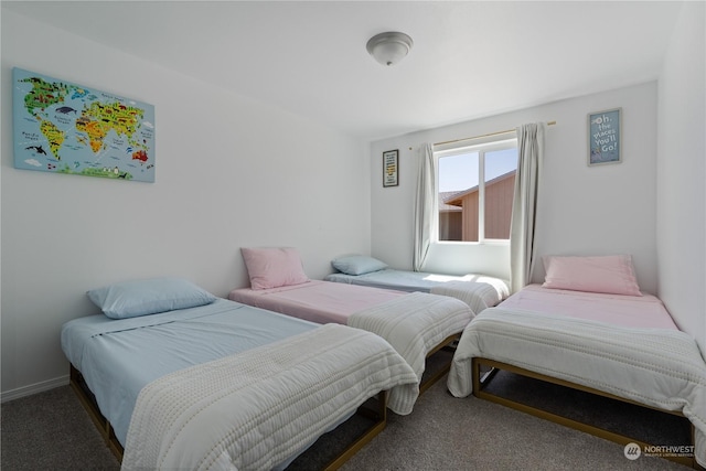 bedroom with dark colored carpet