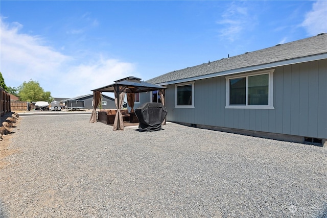 rear view of property with a gazebo and a patio area