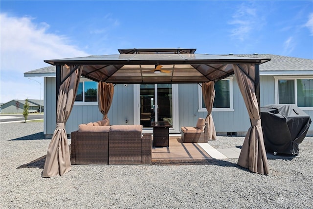 rear view of property featuring a gazebo, an outdoor hangout area, and a patio